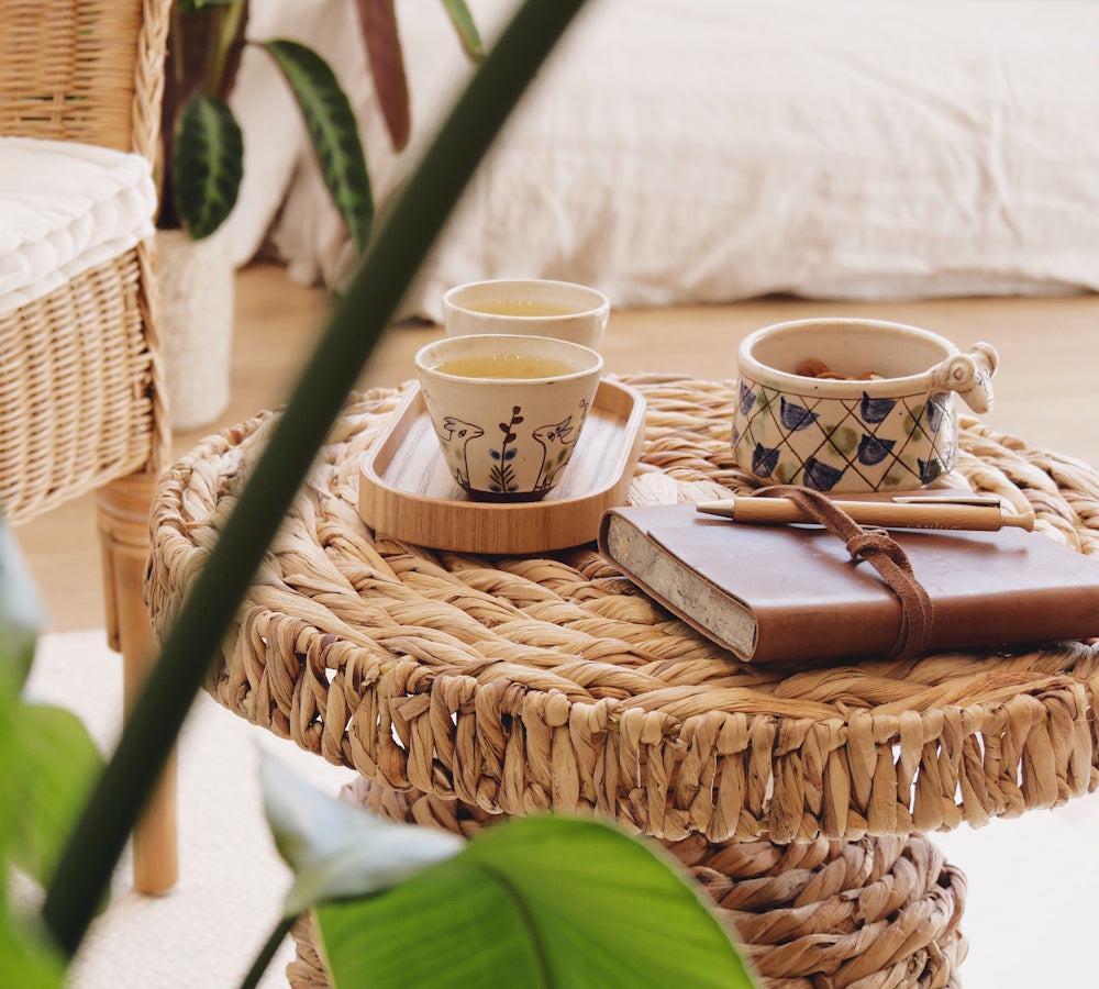 Sitzgruppe mit Teetasse, Snacks und Notizbuch für aurvedische Gesundheitsberatung